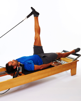 pilates reformer foot in strap for hamstrings