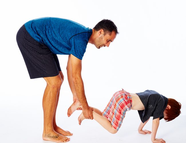 child in wheelbarrow exercise